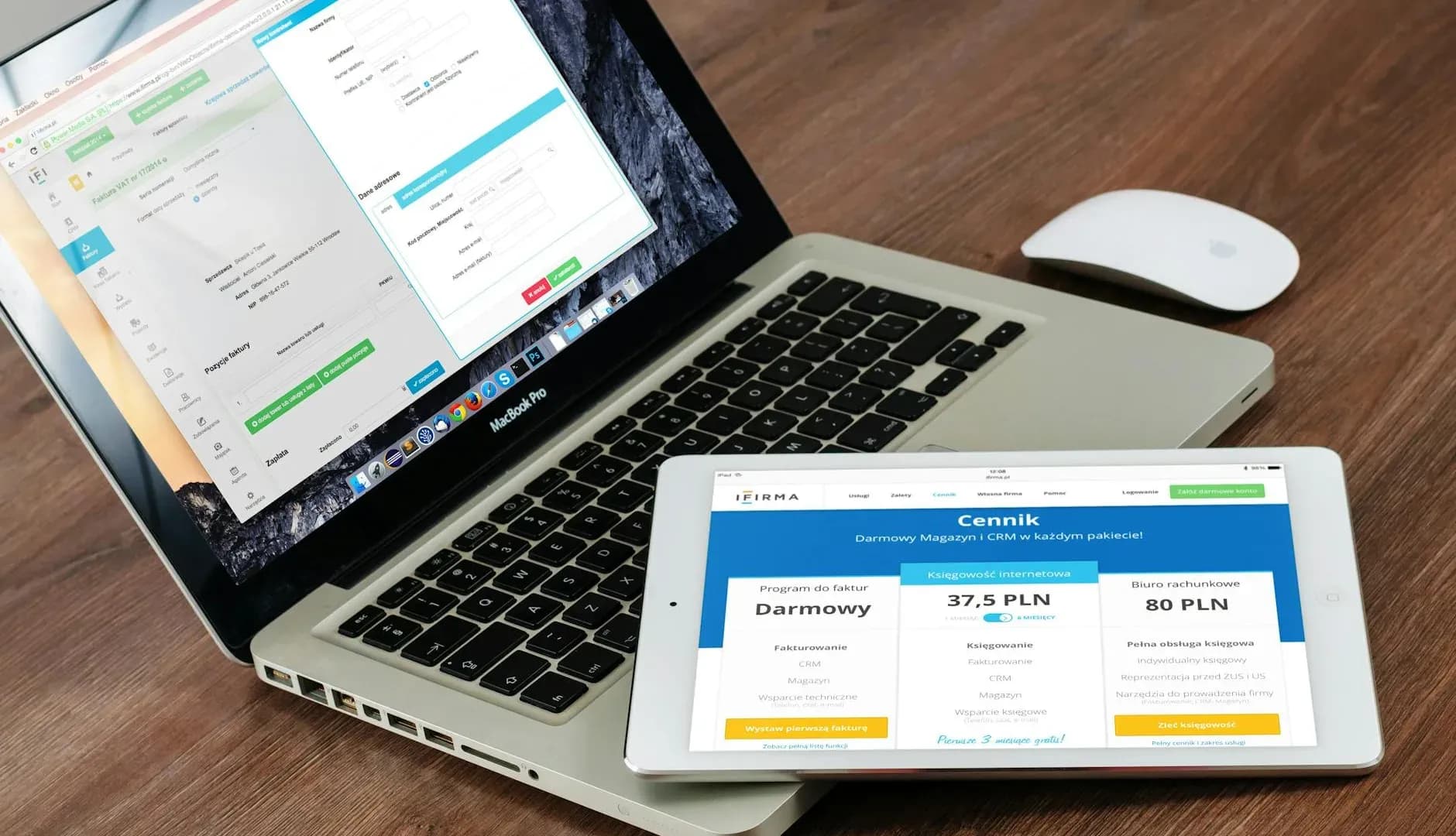 Close-up of a laptop and tablet on a wooden desk, highlighting modern technology for website migration and upgrades.